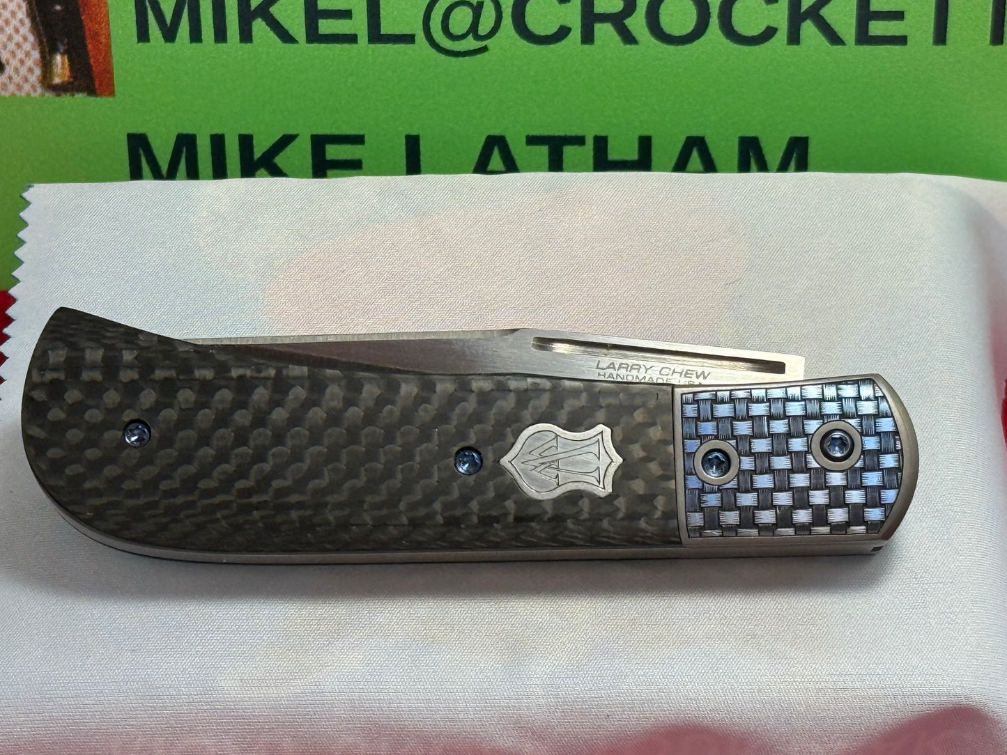 CHEW, LARRY CUSTOM 2023 D/A TRAPPER SHIELD RELEASE CUSTOM ARTWORK BY WILFRED "CHIP" VALTAKIS CUSTOM AUTOMATIC KNIFE CARBON FIBER HANDLES