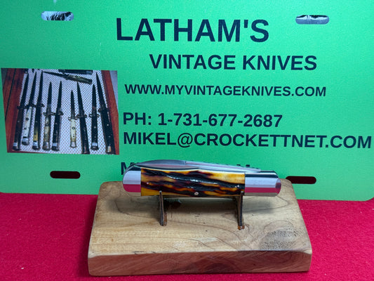 STEIGERWALT, KEN CUSTOM 2010 SEASHELL STAMP SLIP JOINT MANUAL ACTION CUSTOM KNIFE WORMED GROVED AMBER BONE HANDLES