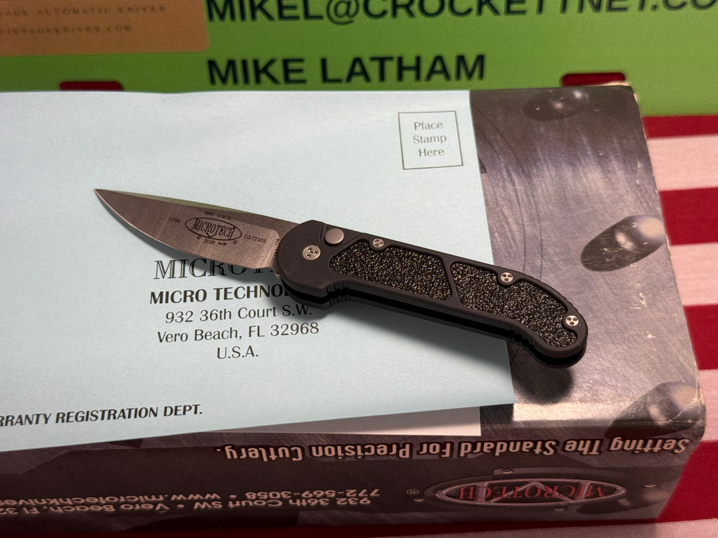 MICROTECH USA 03/2005 TACTICAL MINI U.M.S. STONEWASH PLAIN S/N 1256 TACTICAL AUTOMATIC KNIFE BLACK METAL HANDLES
